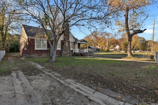 exterior space featuring a porch and a yard