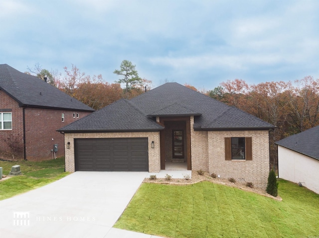 view of front facade featuring a garage and a front lawn