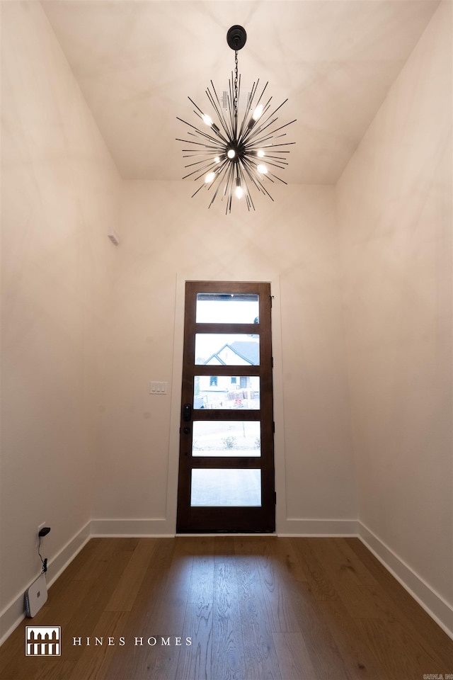 doorway featuring a chandelier and dark hardwood / wood-style flooring