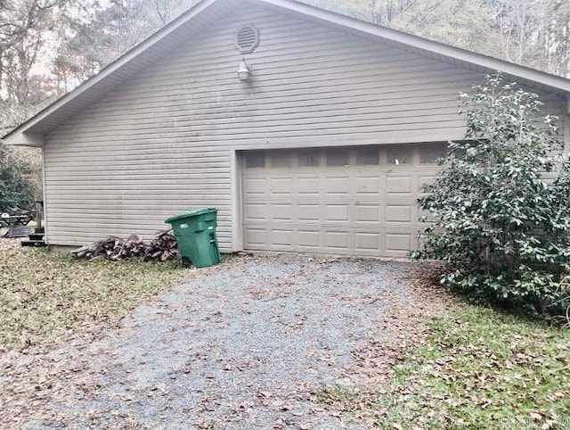 view of home's exterior featuring a garage and an outbuilding