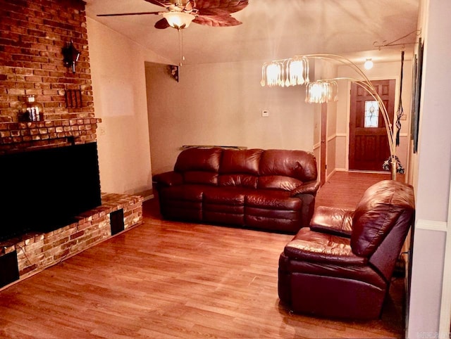 living room with hardwood / wood-style floors, vaulted ceiling, and ceiling fan