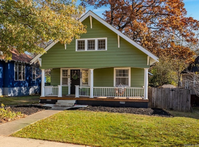 bungalow-style home with a porch and a front yard