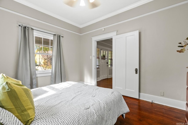 bedroom with ceiling fan, dark hardwood / wood-style flooring, and ornamental molding