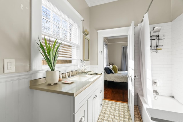 bathroom with shower / bath combo, wood-type flooring, crown molding, and vanity