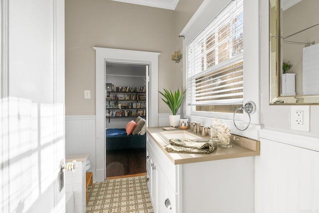 bathroom with hardwood / wood-style floors, vanity, and ornamental molding