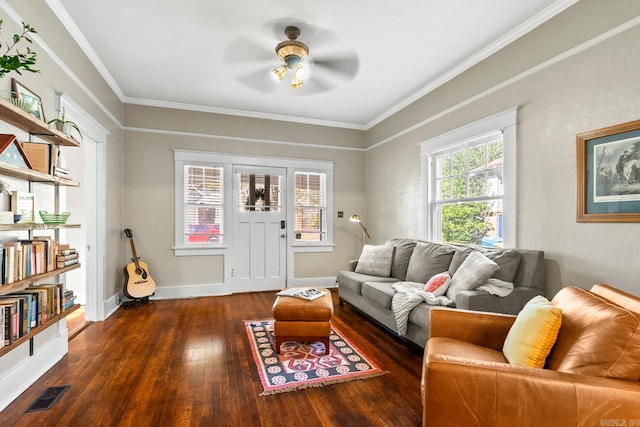 living room featuring dark hardwood / wood-style floors, ceiling fan, and ornamental molding