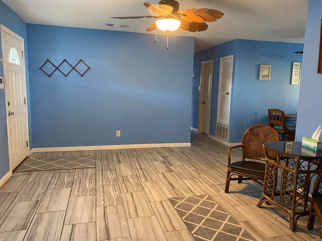 living area with ceiling fan and light hardwood / wood-style floors