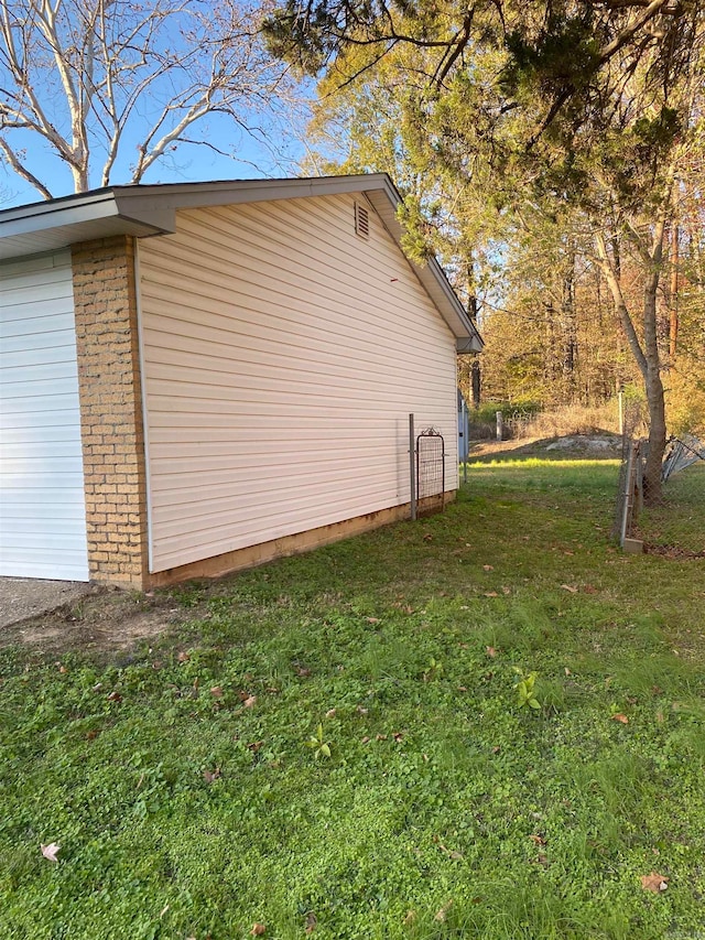 view of side of home featuring a lawn