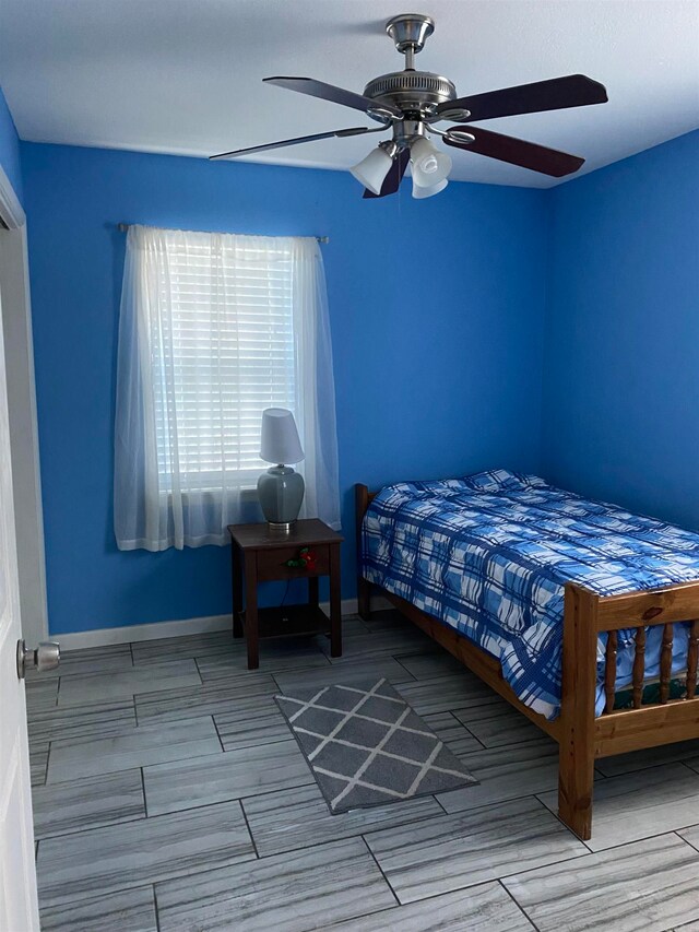 bedroom with ceiling fan and light hardwood / wood-style floors