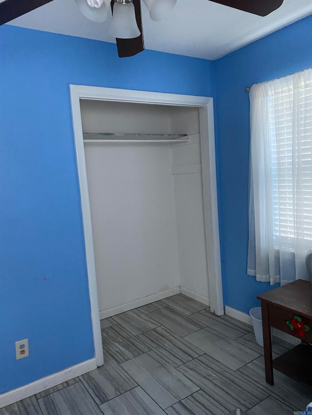 unfurnished bedroom featuring a closet and ceiling fan