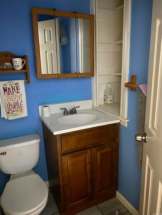 bathroom featuring vanity and toilet