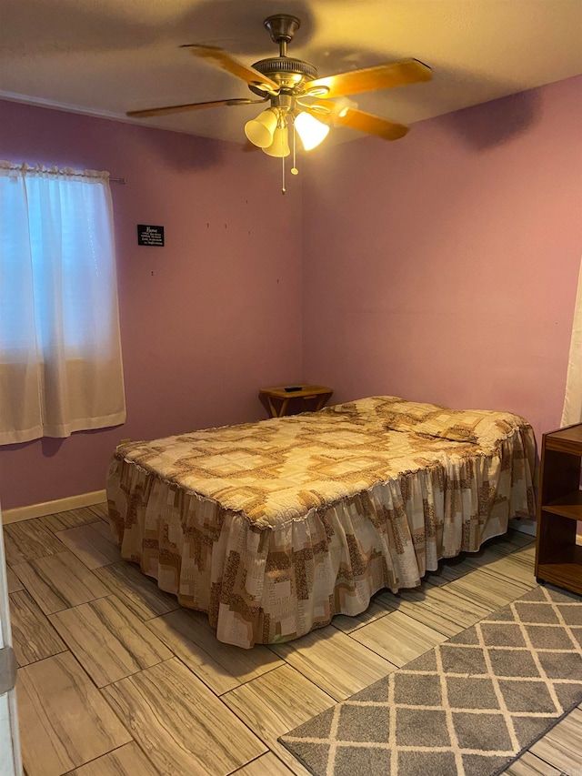 bedroom featuring light wood-type flooring and ceiling fan