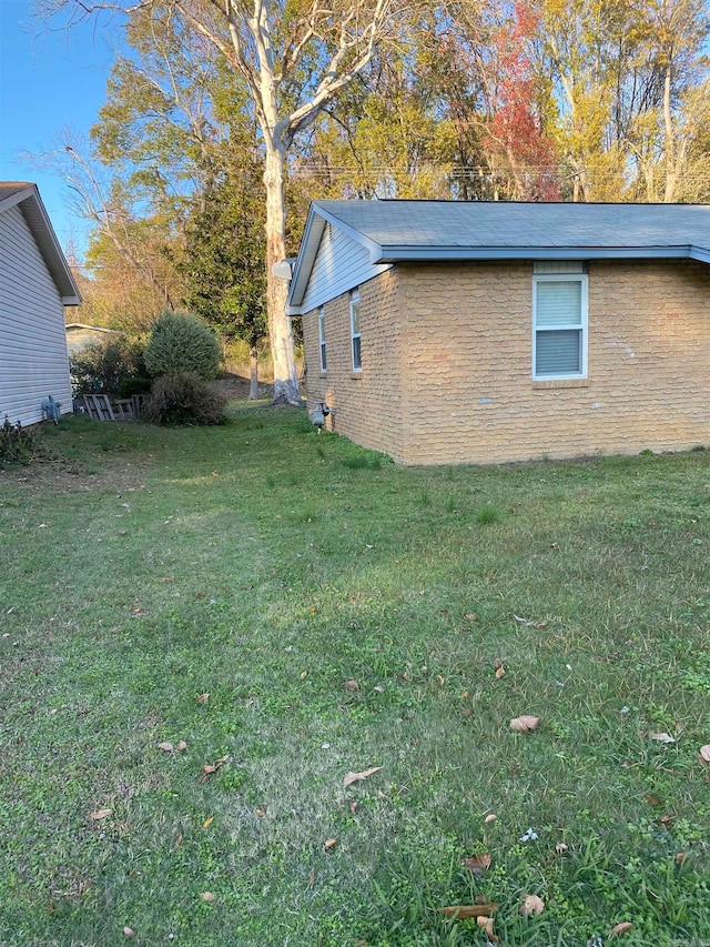 view of property exterior with a yard