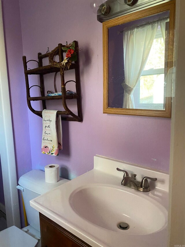 bathroom featuring vanity and toilet