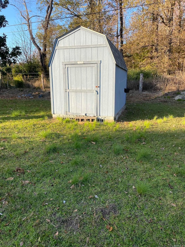 view of outbuilding with a lawn