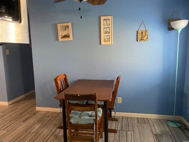 dining space featuring wood-type flooring and ceiling fan