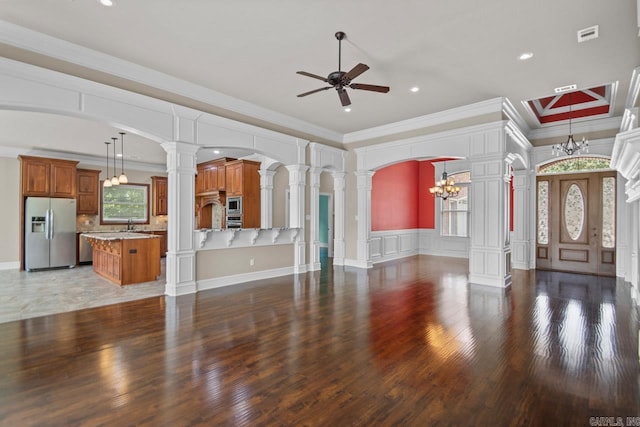 unfurnished living room featuring crown molding, plenty of natural light, and dark wood-type flooring