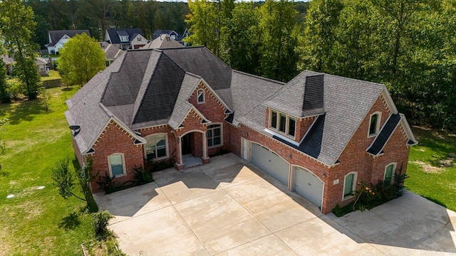 view of front of house featuring a garage and a front lawn