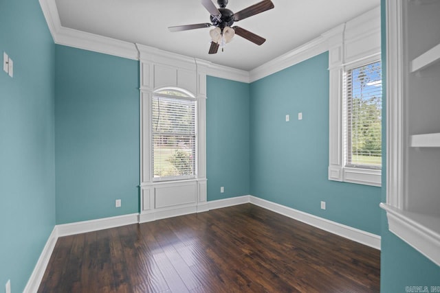 empty room with dark hardwood / wood-style floors, plenty of natural light, crown molding, and ceiling fan