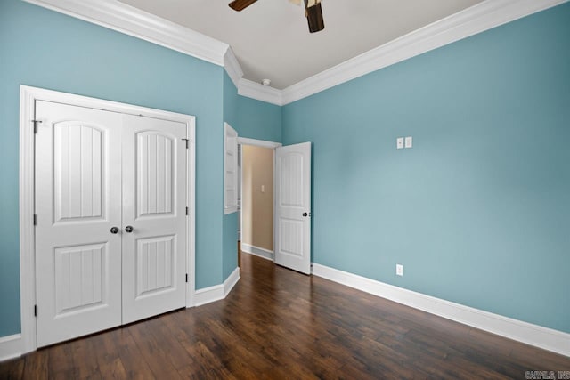 unfurnished bedroom featuring a closet, dark hardwood / wood-style floors, ceiling fan, and crown molding