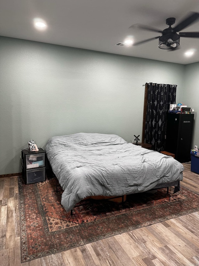 bedroom featuring ceiling fan and wood-type flooring