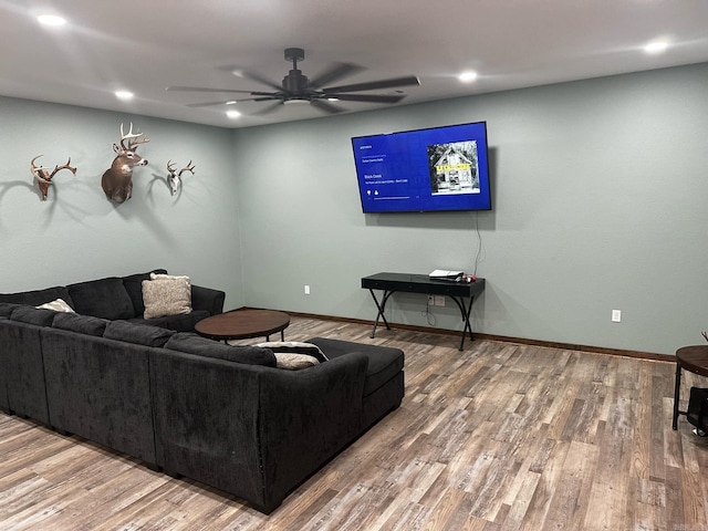 living room featuring hardwood / wood-style floors and ceiling fan