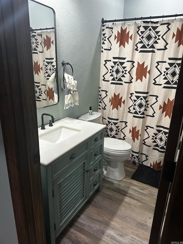 bathroom featuring hardwood / wood-style flooring, vanity, and toilet