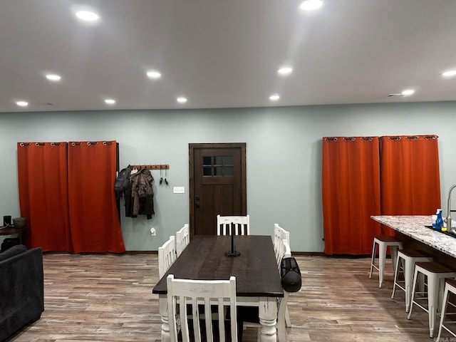 dining space with hardwood / wood-style floors