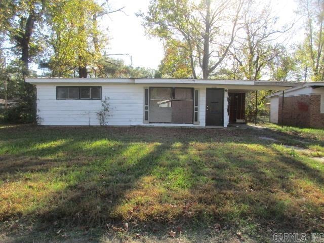 back of house with a yard and a carport