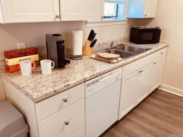 kitchen with white cabinets, sink, white dishwasher, and wood-type flooring