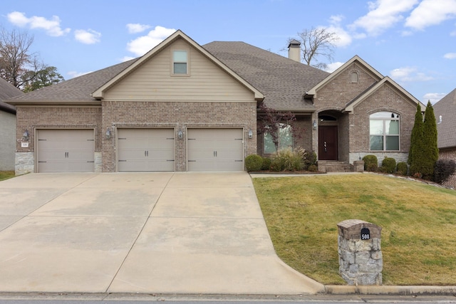 view of front of home featuring a garage and a front yard