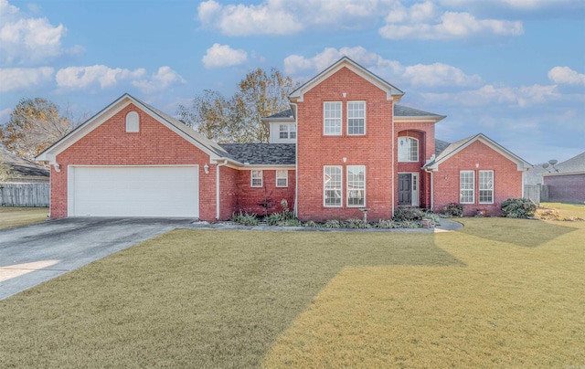 view of front property featuring a garage and a front yard