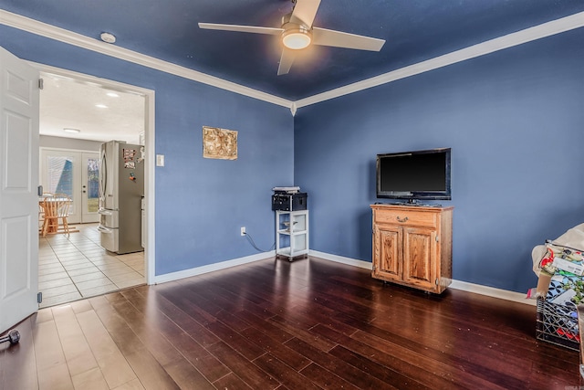 living room with wood-type flooring, french doors, ornamental molding, and ceiling fan