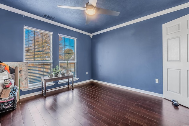 spare room featuring a textured ceiling, dark hardwood / wood-style flooring, ceiling fan, and crown molding