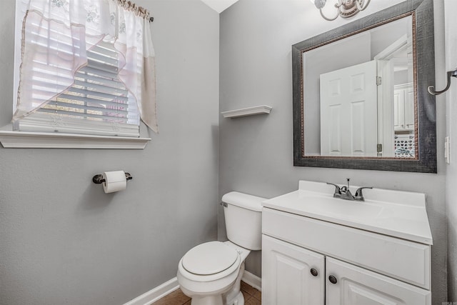 bathroom featuring tile patterned flooring, vanity, and toilet