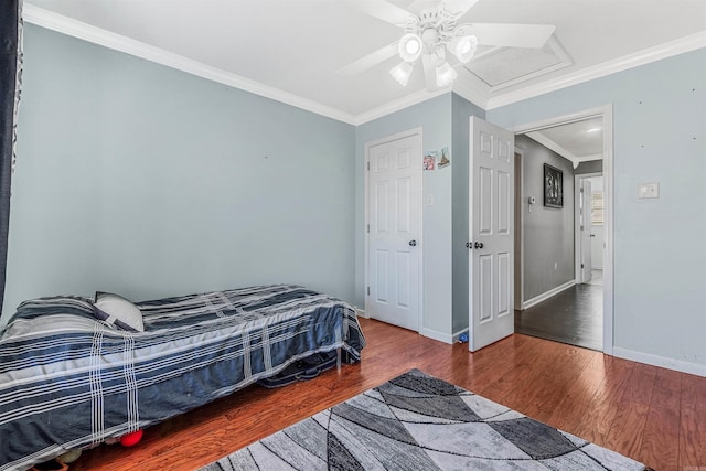 bedroom with ceiling fan, ornamental molding, and hardwood / wood-style flooring