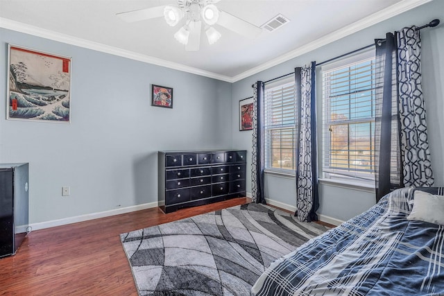 bedroom with ceiling fan, dark hardwood / wood-style flooring, and ornamental molding