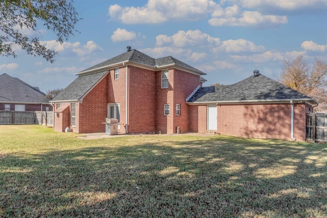 back of house featuring a yard