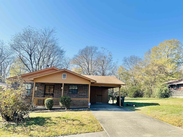 view of front of home with covered porch, a front lawn, and a carport