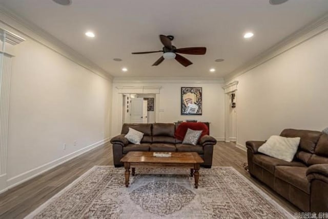 living room with hardwood / wood-style floors, ceiling fan, and crown molding