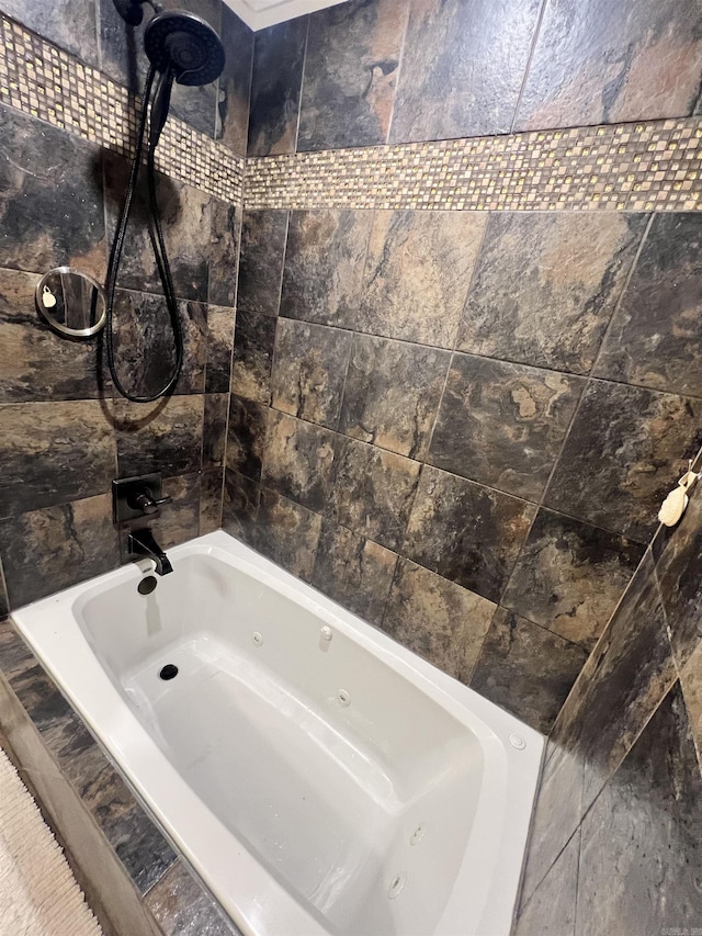 bathroom with tiled shower / bath combo and tile walls