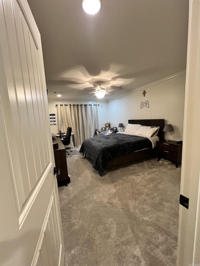 carpeted bedroom with ceiling fan and ornamental molding