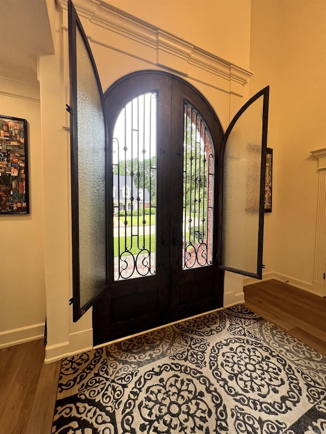 foyer entrance featuring french doors and hardwood / wood-style floors