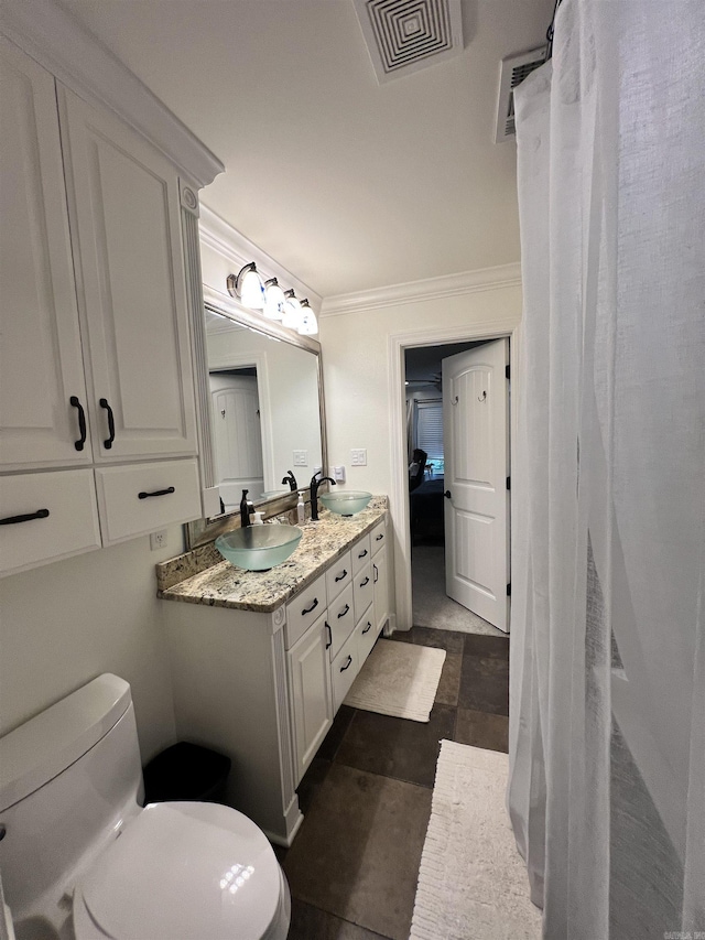 bathroom featuring vanity, toilet, and ornamental molding