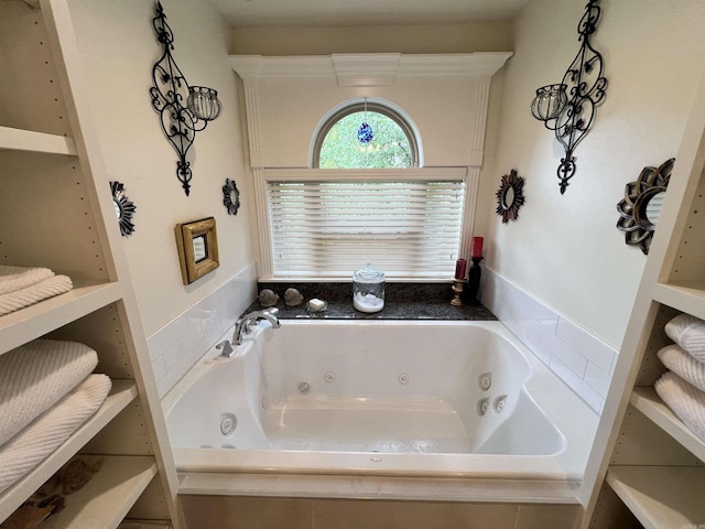 bathroom featuring tiled bath