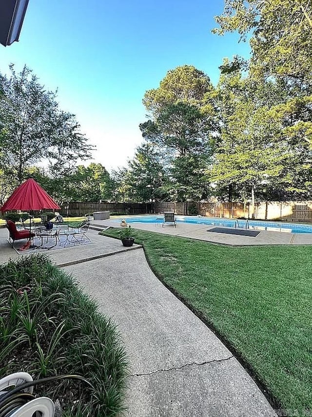 view of pool featuring a patio area and a lawn