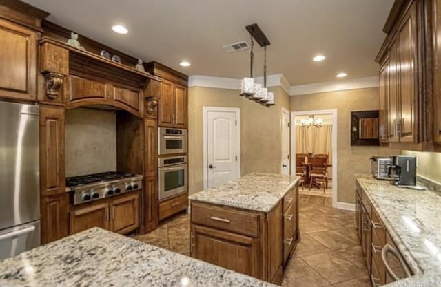 kitchen with a center island, crown molding, decorative light fixtures, light stone counters, and stainless steel appliances