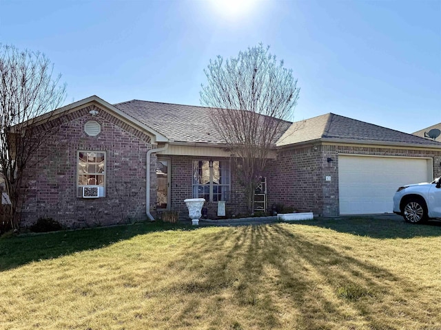 ranch-style house featuring brick siding, an attached garage, and a front yard