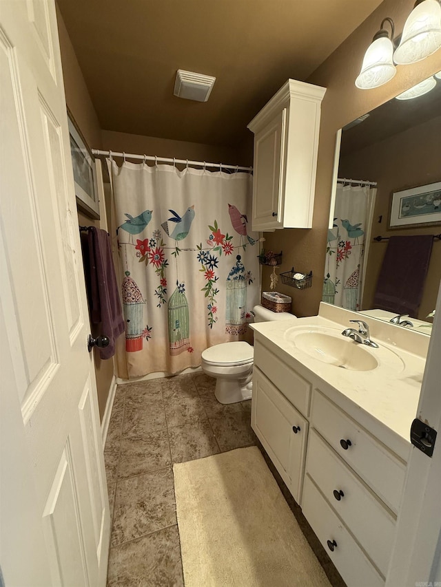 full bath featuring vanity, a shower with shower curtain, visible vents, tile patterned flooring, and toilet