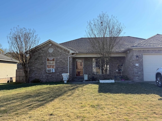 ranch-style home featuring a front yard, brick siding, and a garage